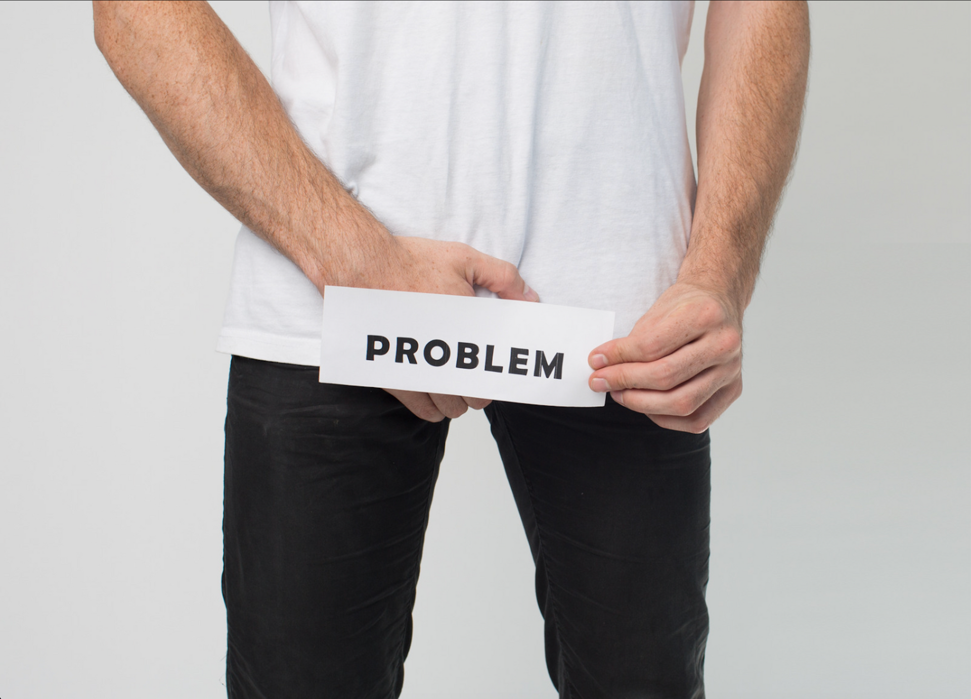 A man is holding a piece of paper with the word problem on it.