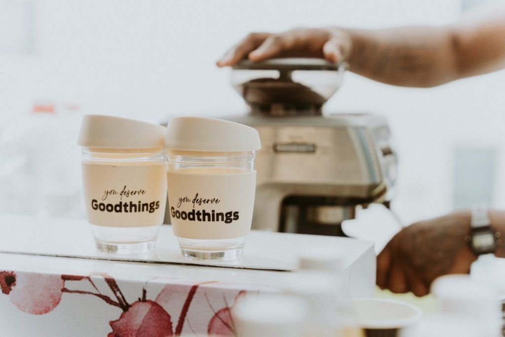 A person is pouring coffee into a cup that says good things on it.