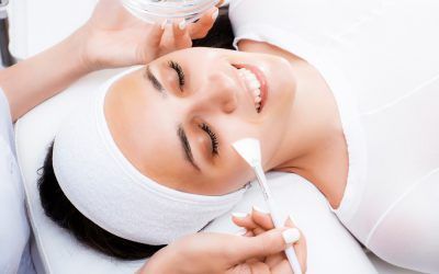 A woman is getting a facial treatment at a beauty salon.
