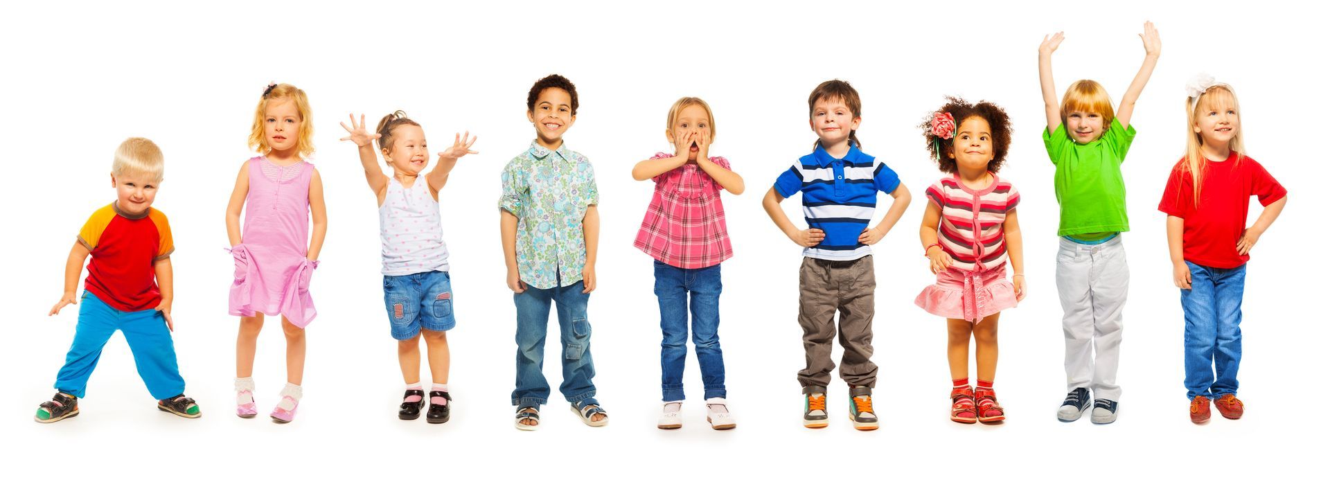 A group of children are standing in a row with their hands in the air.