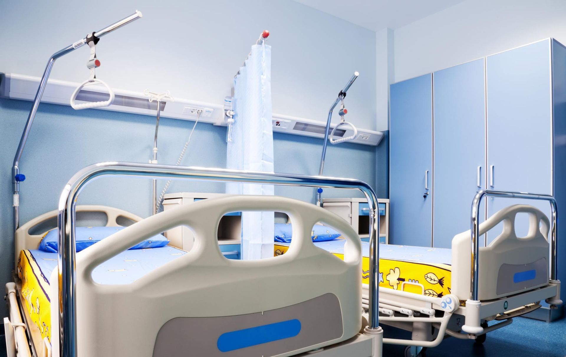 a hospital room with a bed and medical equipment