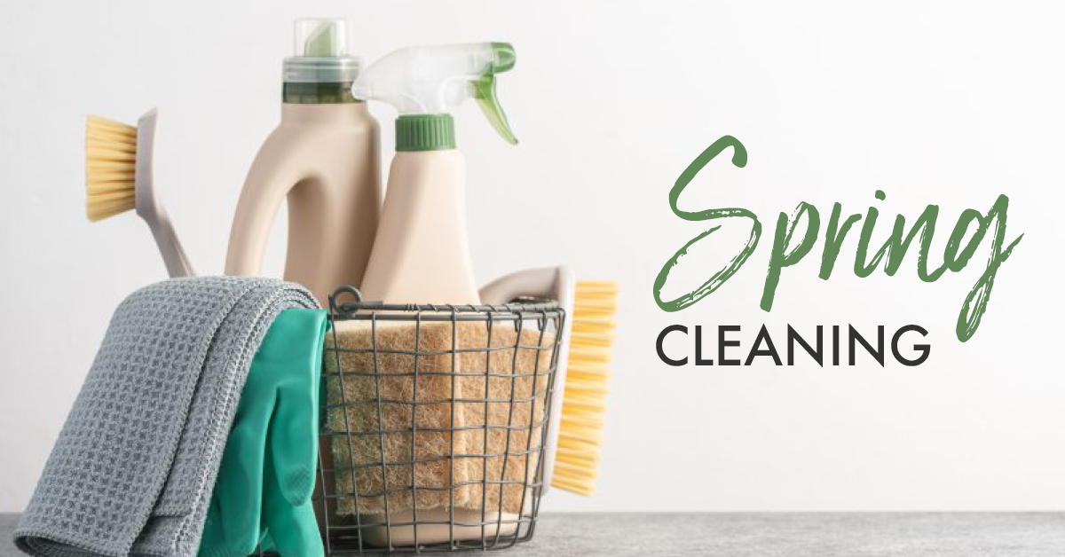 Cleaning supplies in a wire basket: spray bottles, brushes, gloves, and cloths; the words