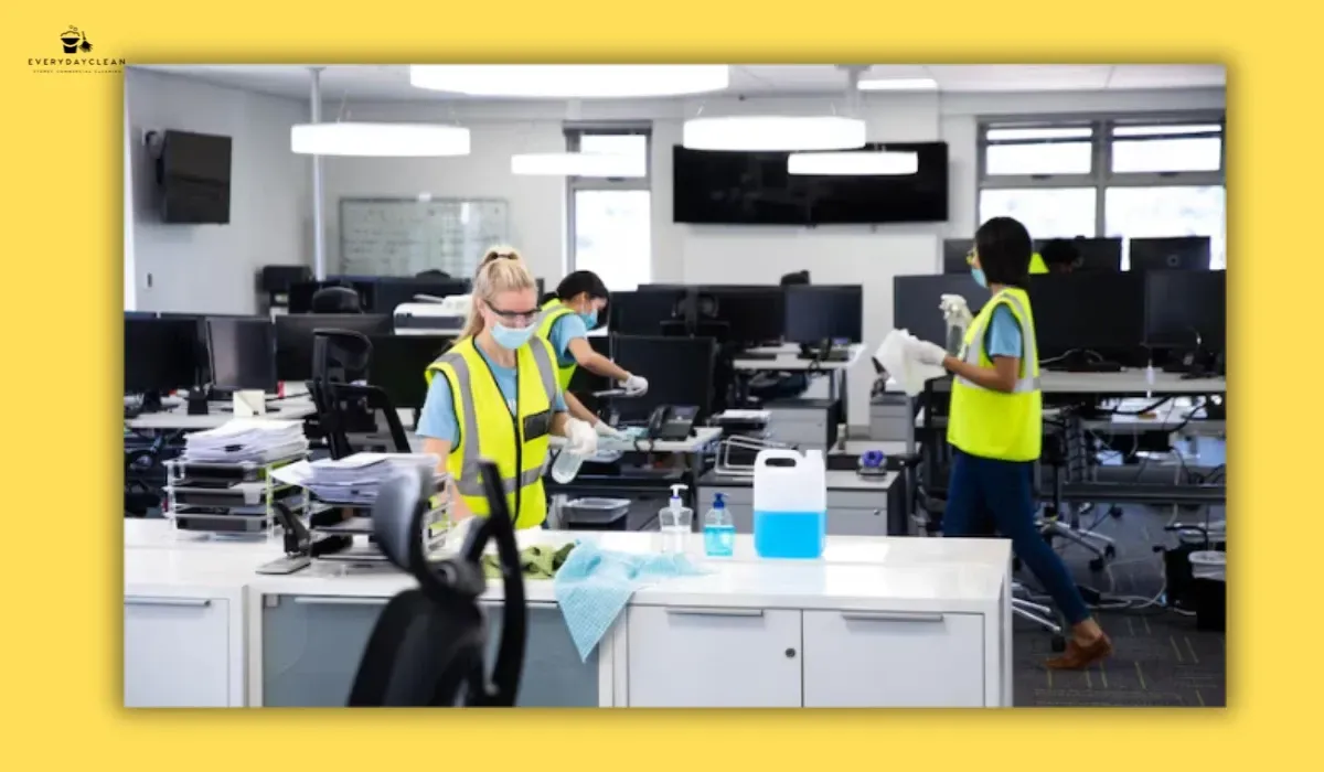 Cleaning monitor screens and office equipment as part of an office desk cleaning routine
