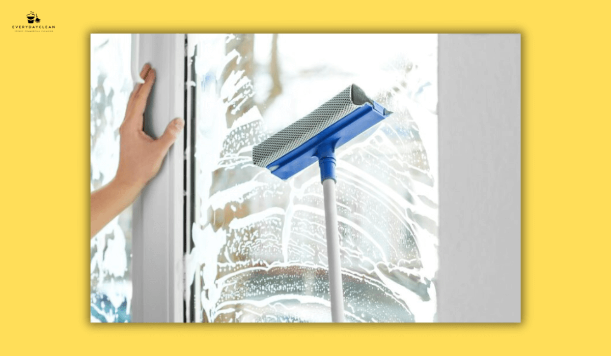  cleaning windows with squeegee

