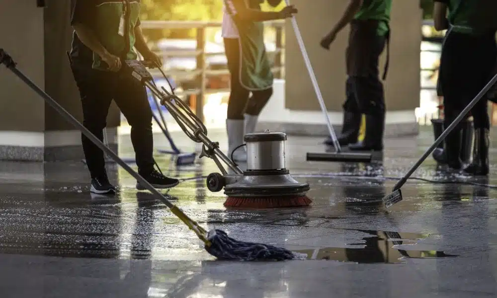 Professional office cleaning standards in practice with mops, squeegees, and floor buffer