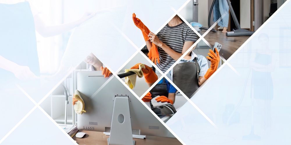 Person cleaning a desk, wearing gloves, in a bright room.
