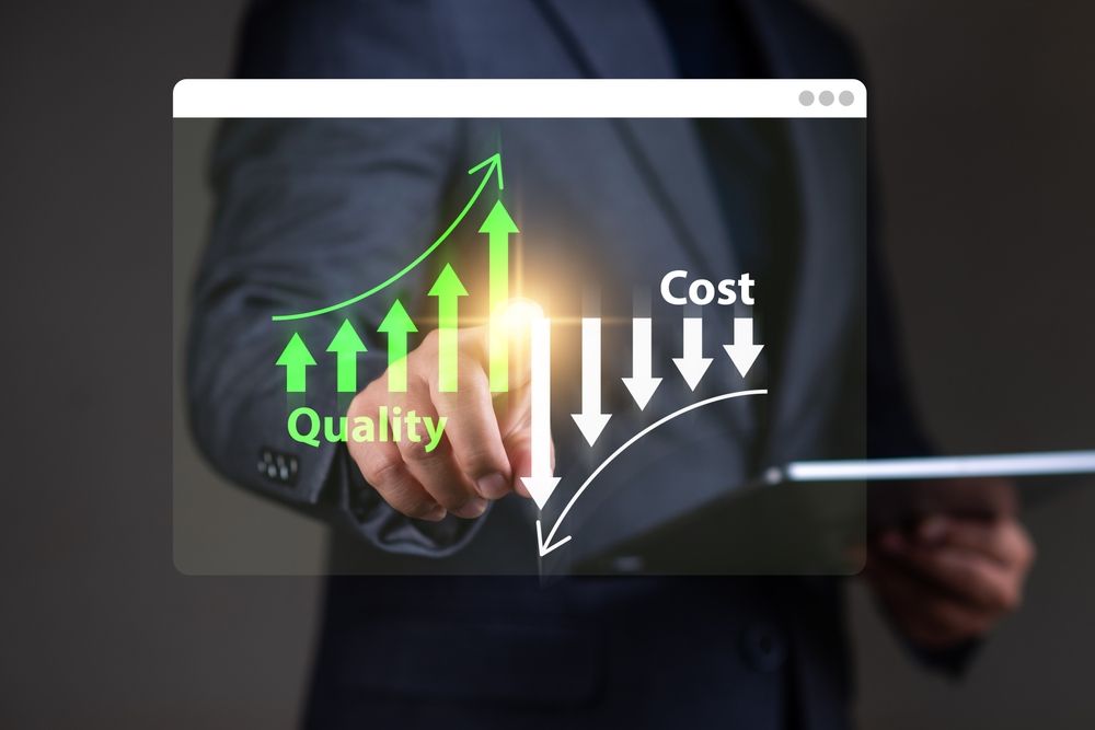 A person points at a screen showing rising quality and falling costs, represented by arrows.