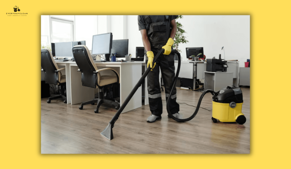 office cleaner vacuuming carpet workspace