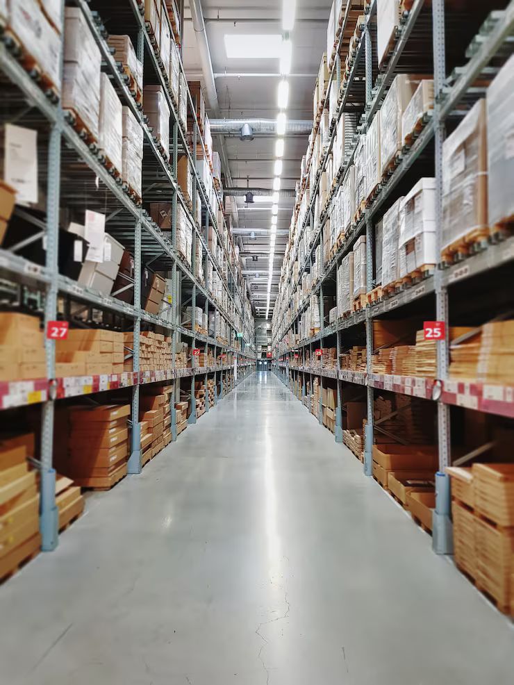 Warehouse aisle with shelves stacked high with boxes and goods.