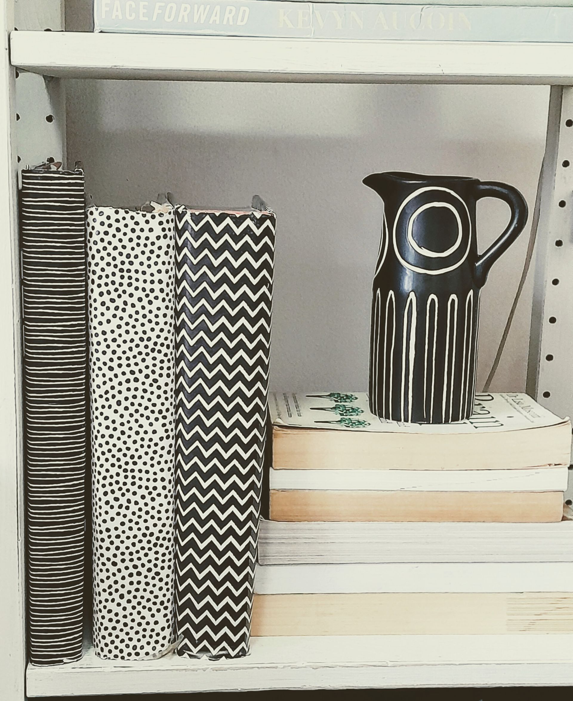 Styled shelving detail with decorative books and ceramics for property staging