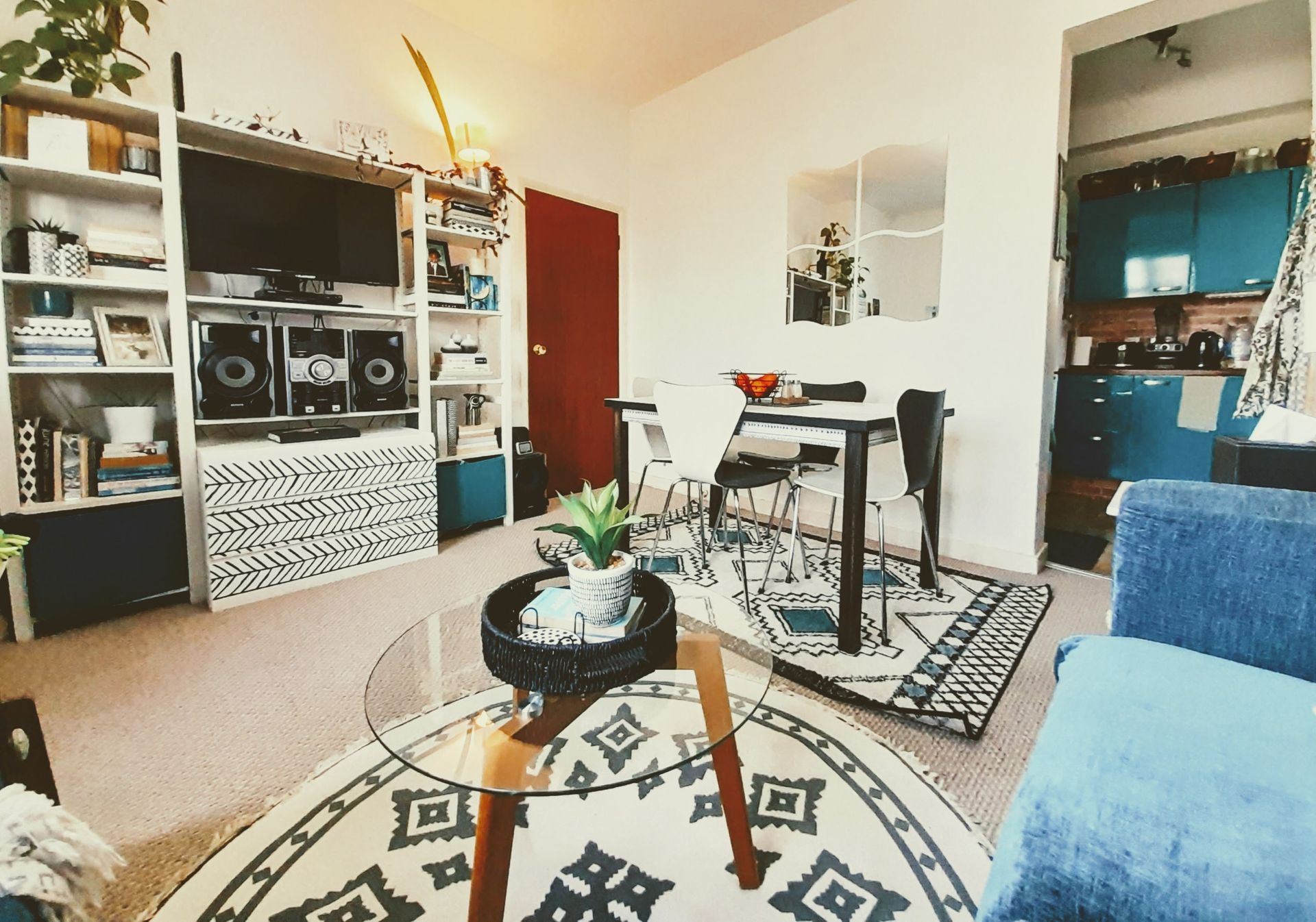 Occupied living room prepared for sale with decluttered shelving and neutral styling