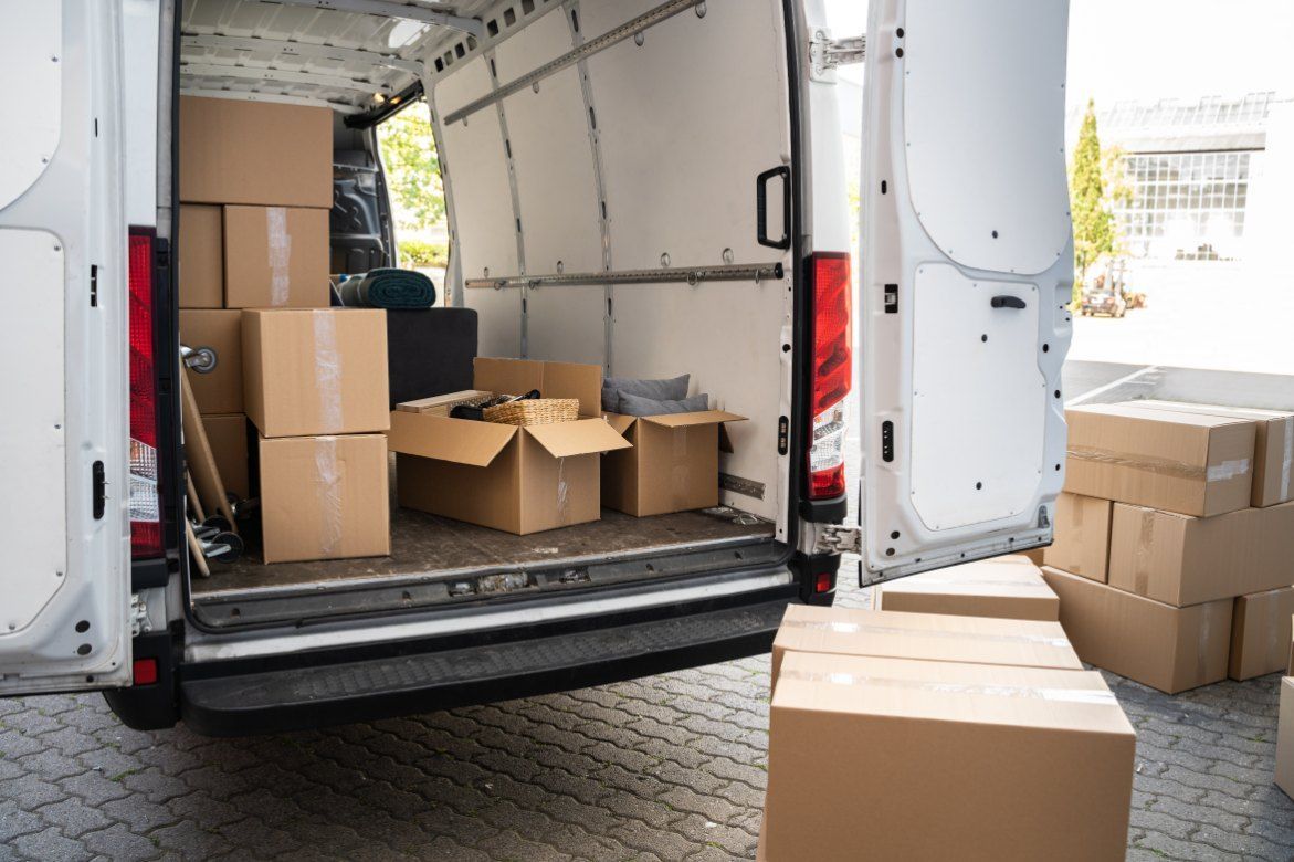 Two Men Are Moving Boxes in an Office — Buck Removals & Storage in Dubbo, NSW