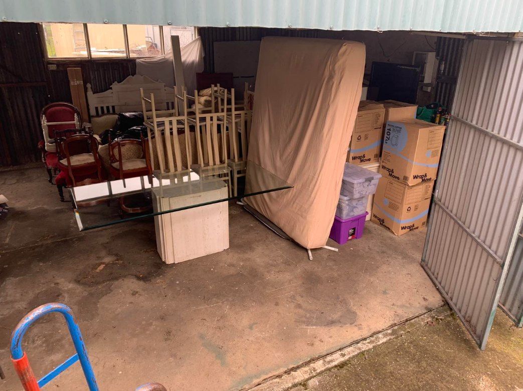 A Garage Filled With Lots of Furniture and Boxes — Buck Removals & Storage in Dubbo, NSW
