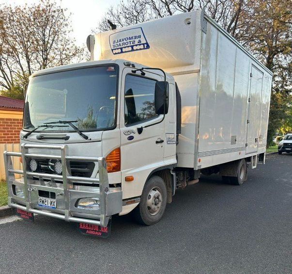 Removals and storage truck parked on the roadside.