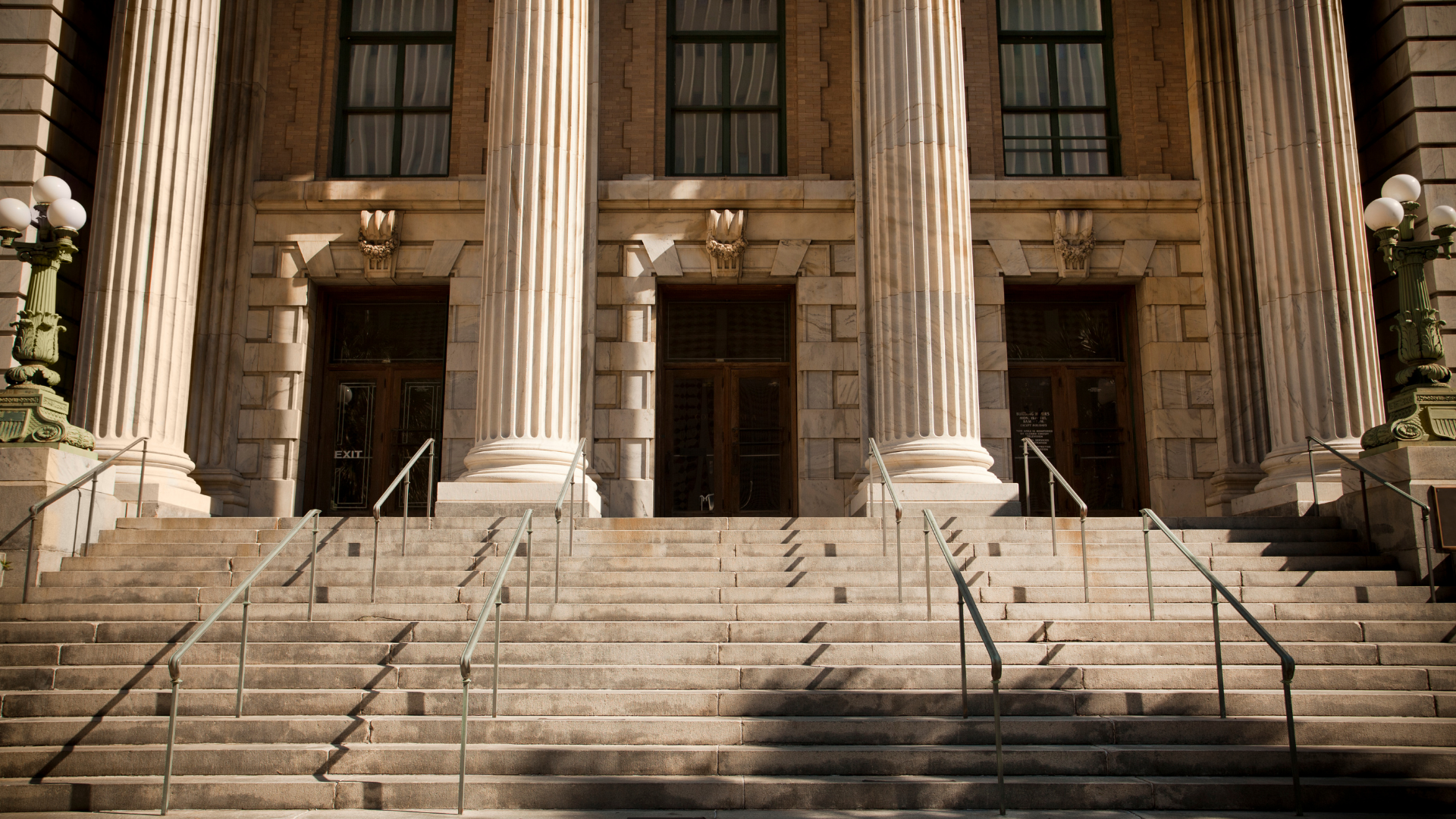 Stone steps leading to a grand neoclassical building with tall columns and multiple entrances