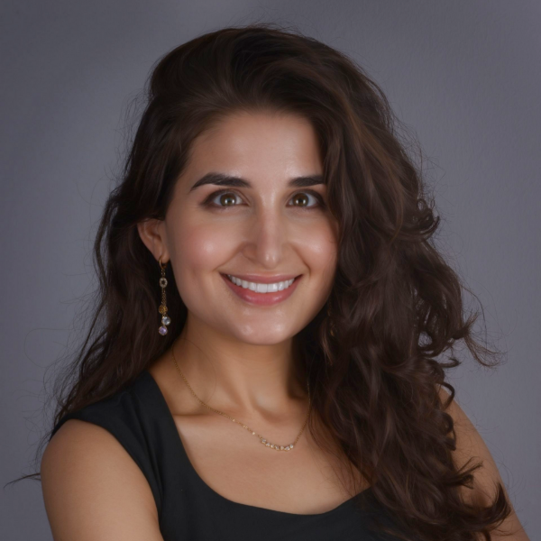 Dr. Dashiff with long dark hair in a black sleeveless top against a gray background