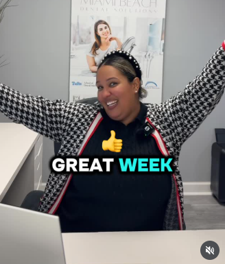 Woman in an office with arms raised, smiling, with “GREAT WEEK” text overlay.