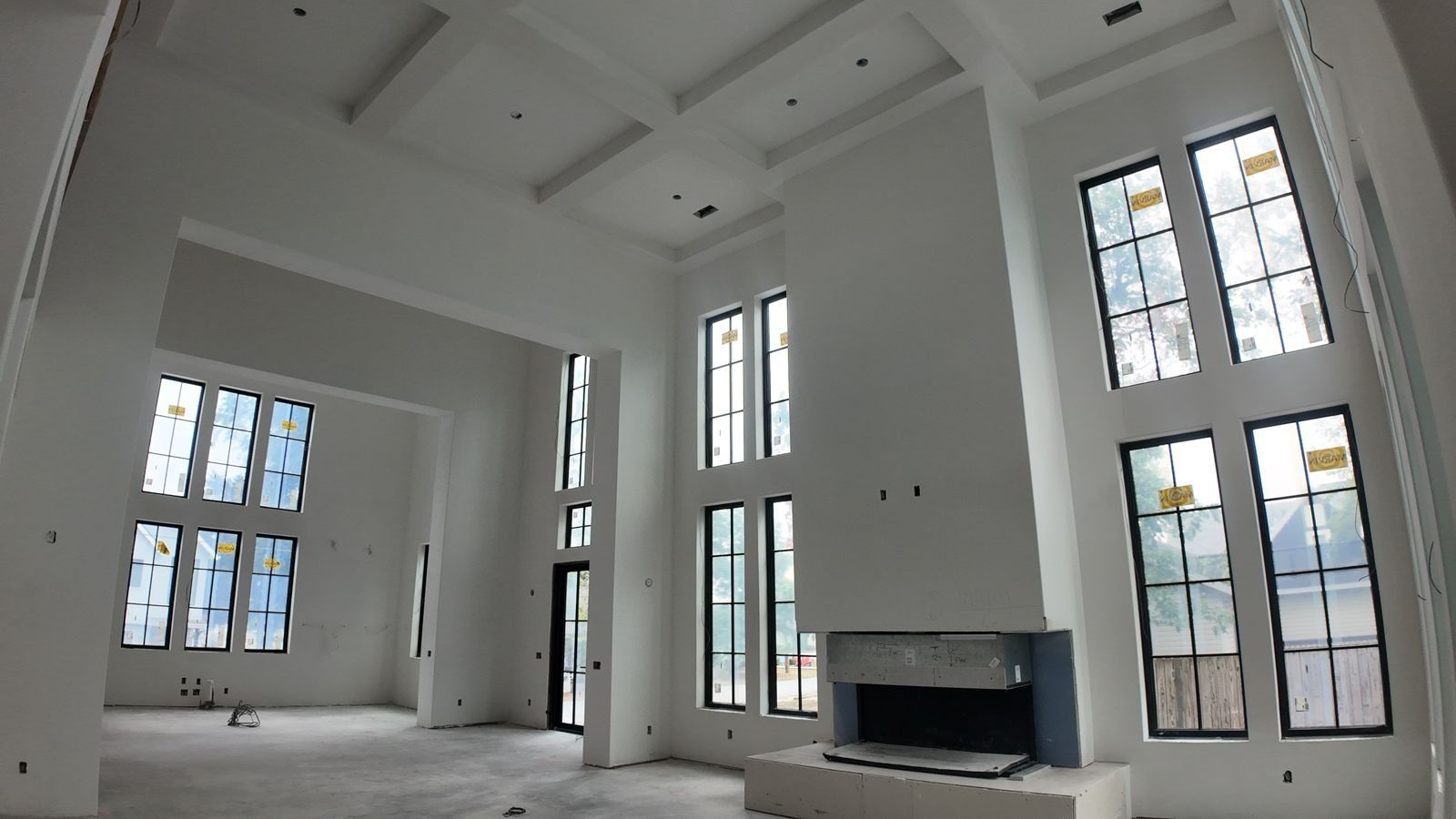 Great room with coffered ceiling, smooth Level 5 drywall, Bentonville custom home