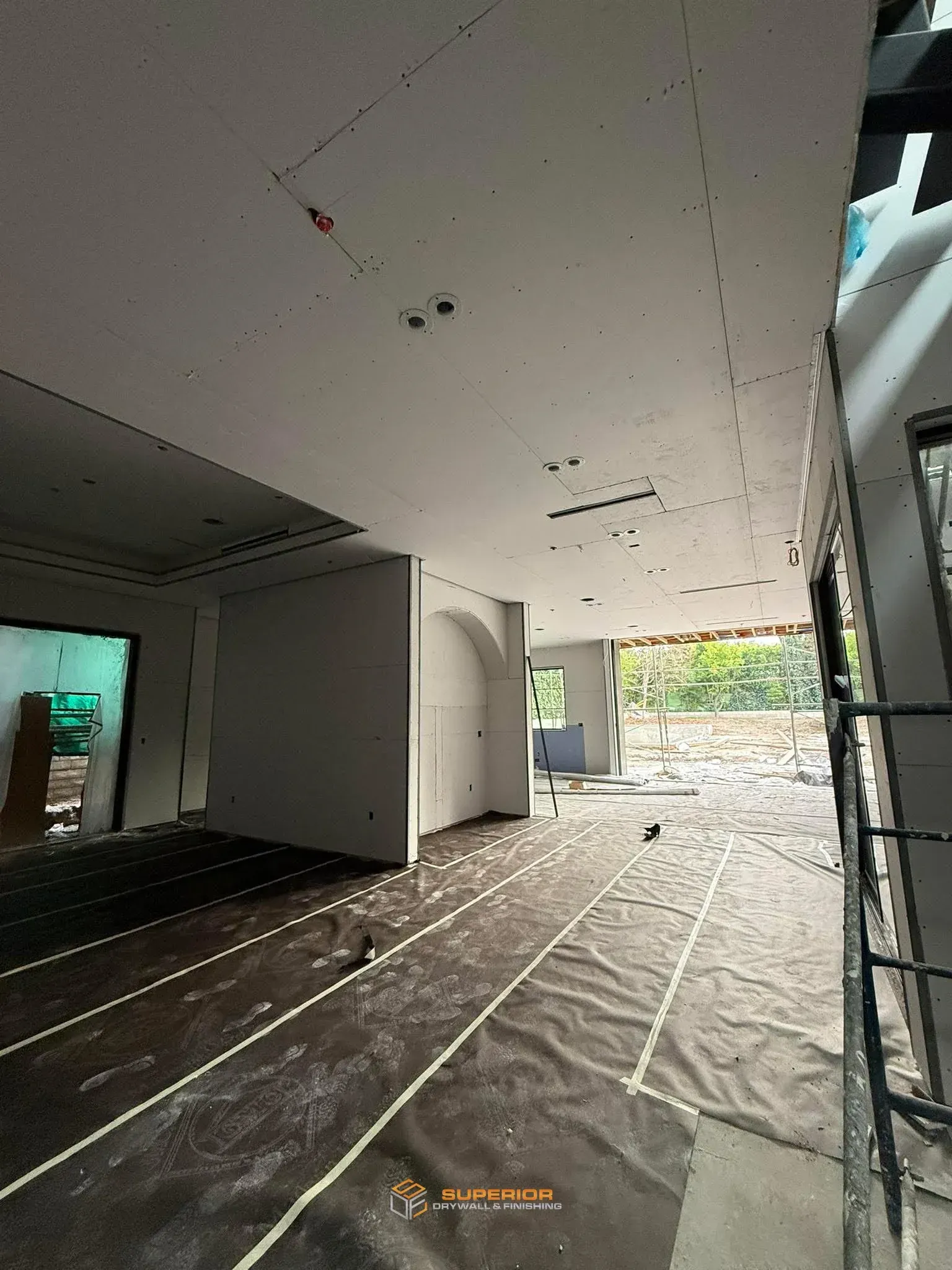 Drywall hung and floors protected with paper on a Northwest Arkansas custom home by Superior Drywall & Finishing