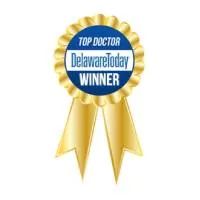 Blue and gold “Top Doctor DelawareToday Winner” award ribbon badge