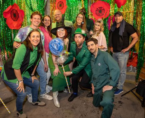 Group in colorful costumes celebrating together at a themed event party