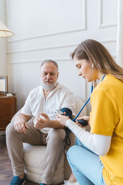 Therapist and client seated in a bright room, discussing a topic while the therapist takes notes