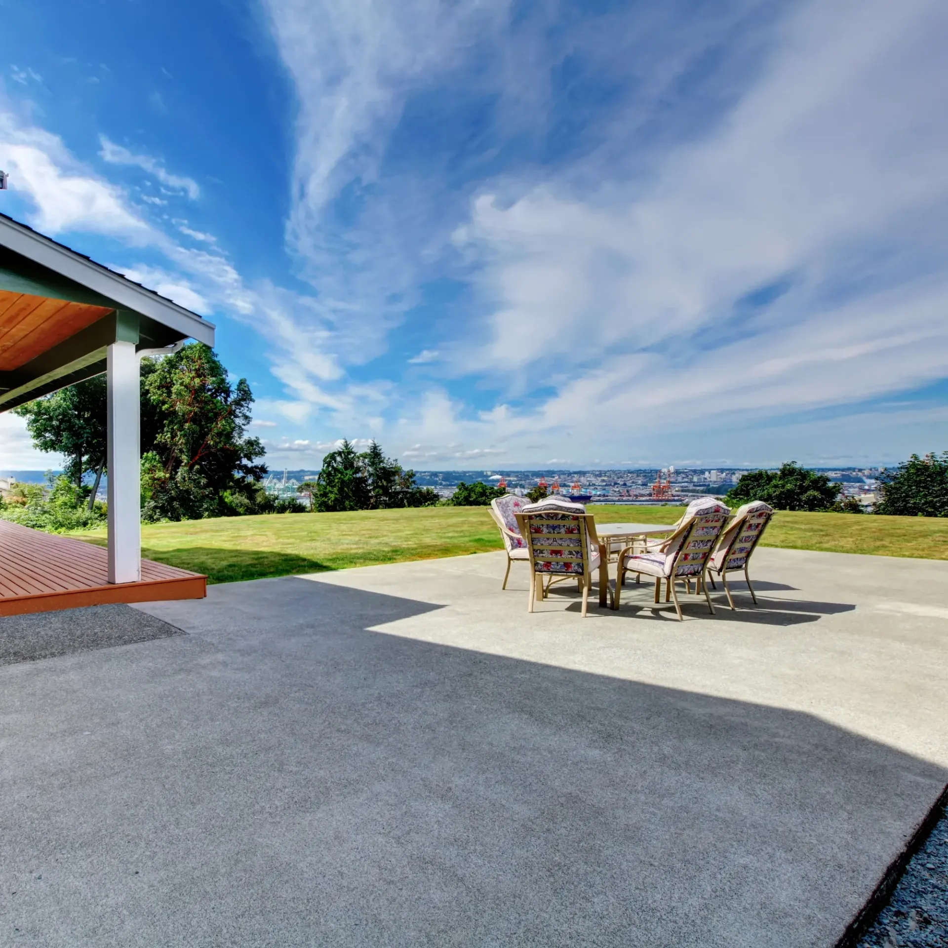 Sanchez Electric and Remodeling - A patio with a table and chairs with a view of the ocean