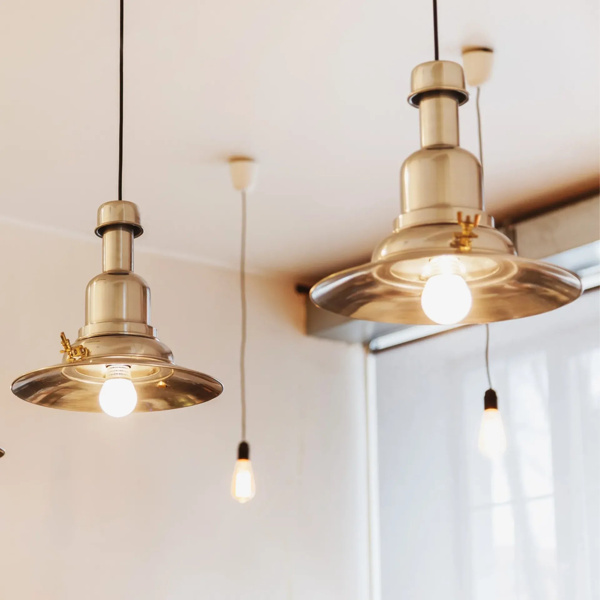 Sanchez Electric and Remodeling - Two pendant lights are hanging from the ceiling in a room