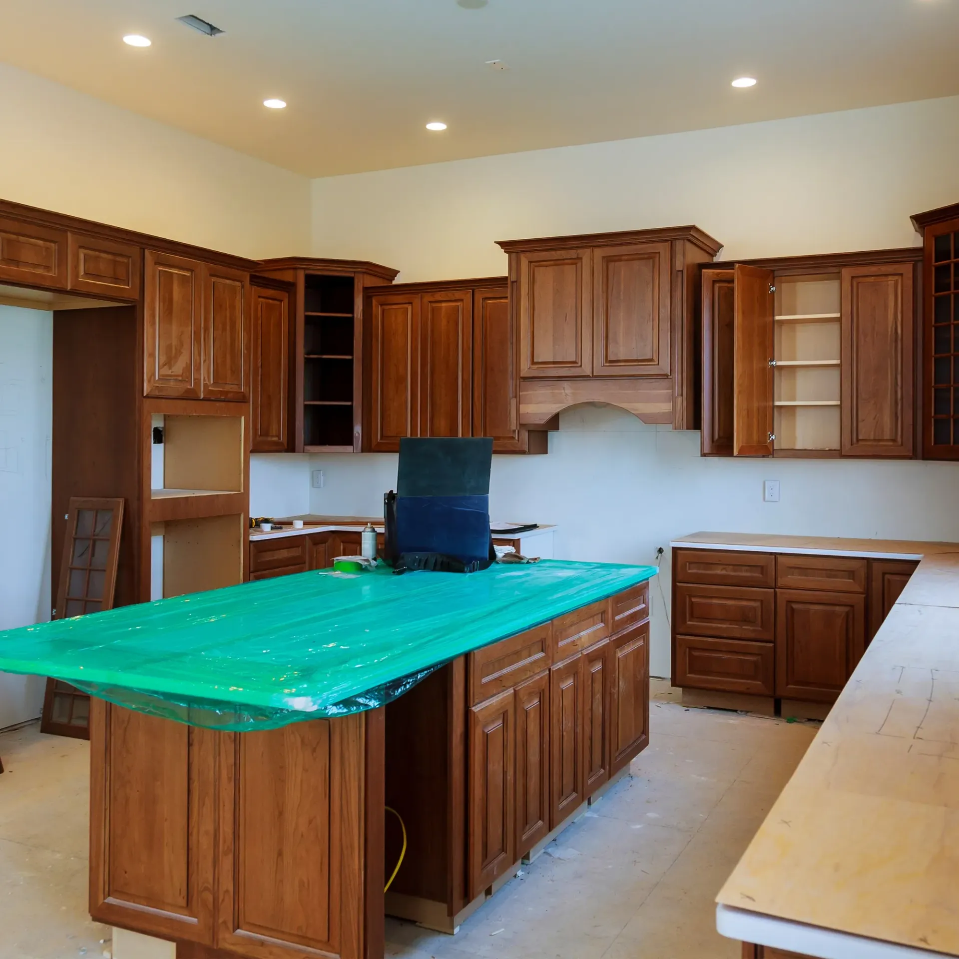 Sanchez Electric and Remodeling - A kitchen with wooden cabinets and a green table