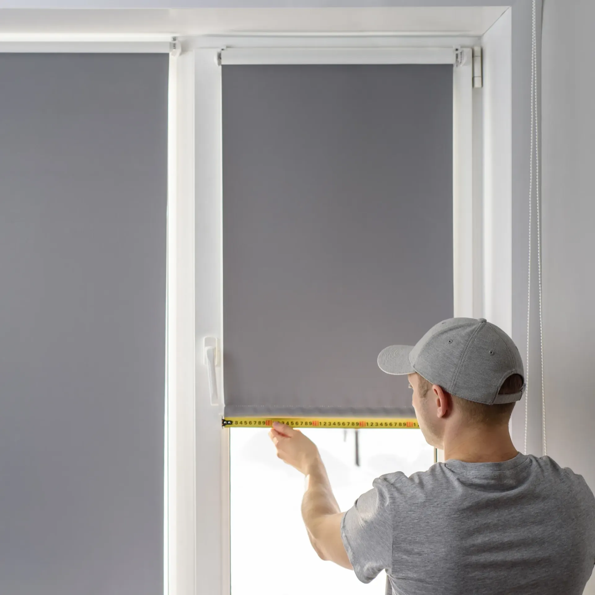 Sanchez Electric and Remodeling - A man is measuring a window blind with a tape measure.