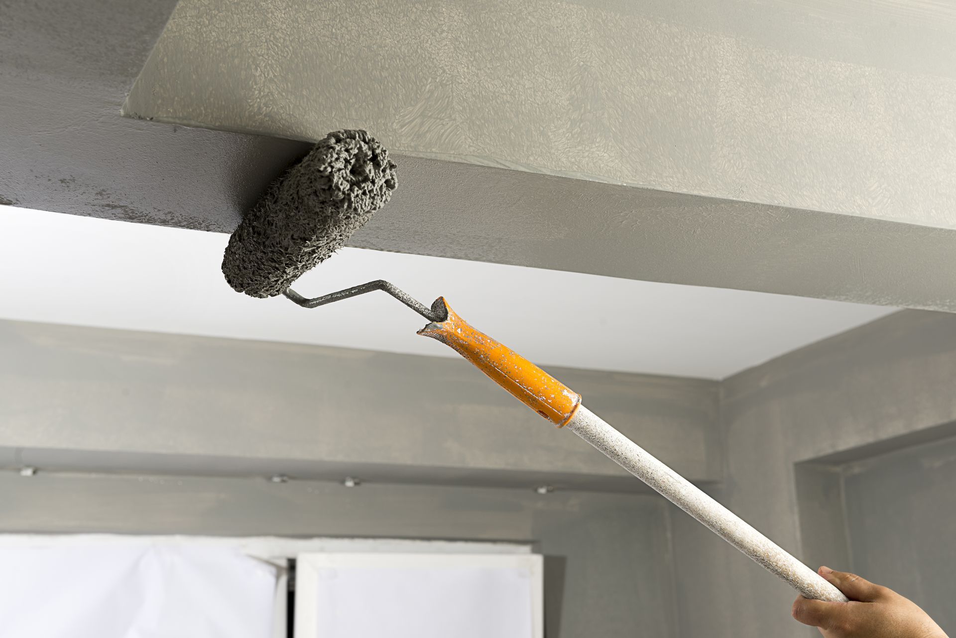 Person using a paint roller
