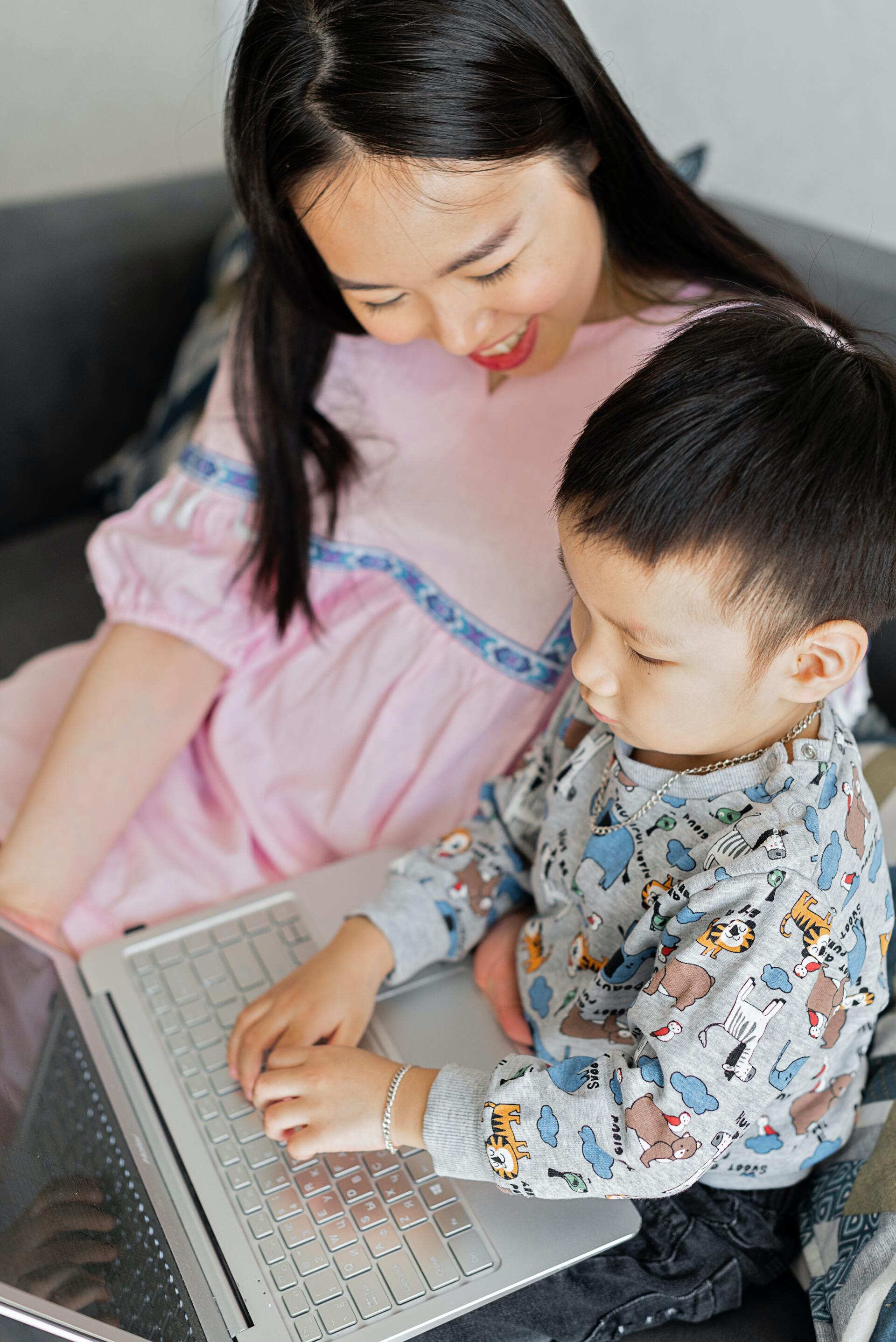 Mom and small child using laptop