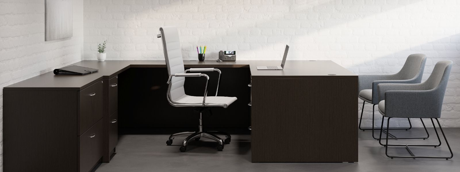 There is a desk with a chair and a laptop on it.