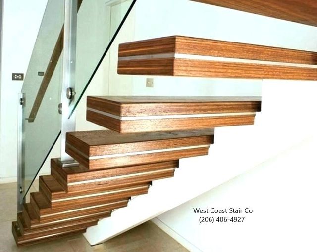 Floating wood stair treads with a glass railing