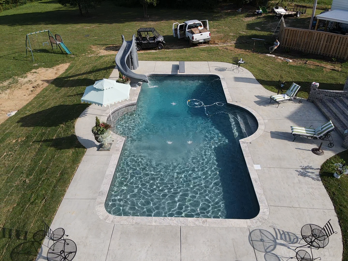 An aerial view of a large swimming pool with a slide.