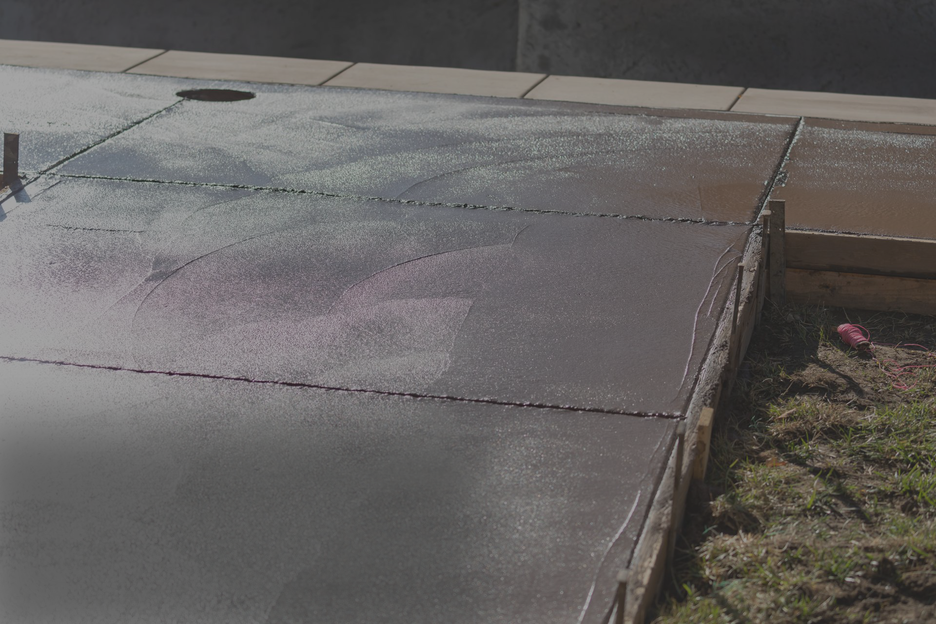 A concrete driveway with a hole in the middle of it
