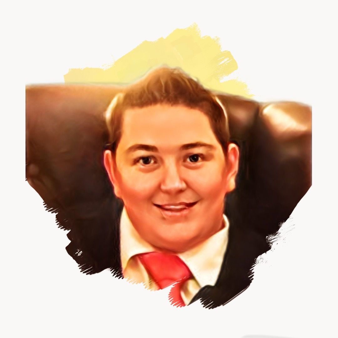A man in a suit and tie is sitting in a chair.
