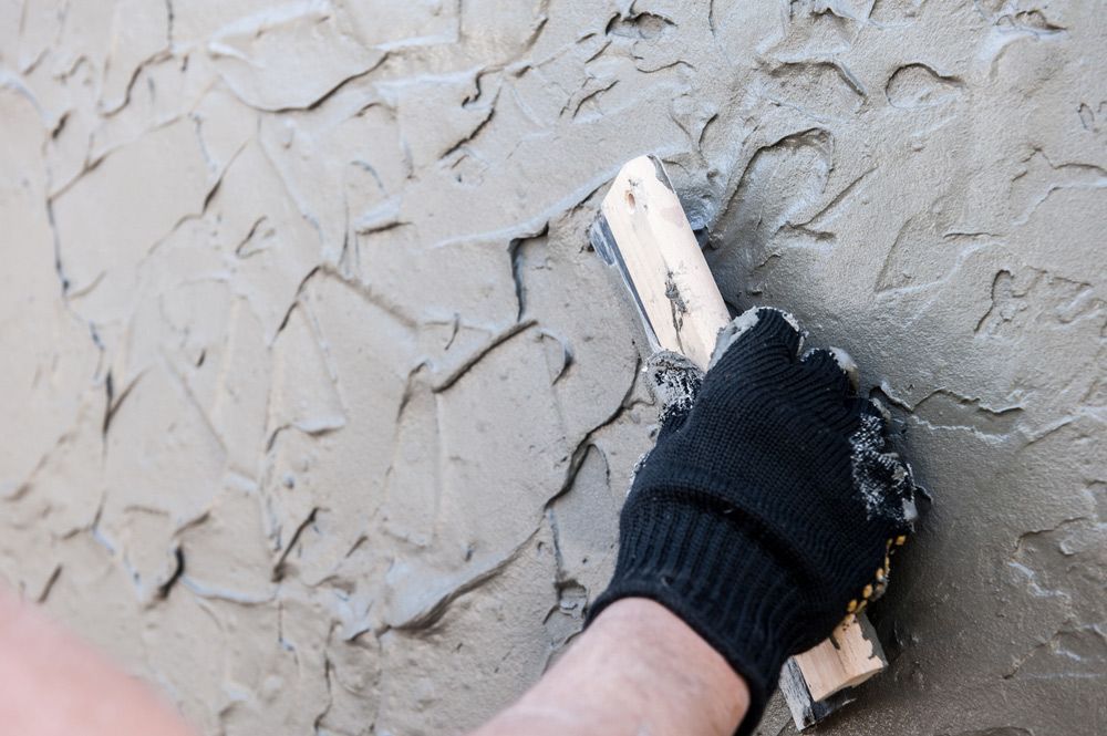 A Gloved Hand Uses a Trowel — Robert Seeliger Painter And Decorator in Dubbo, NSW