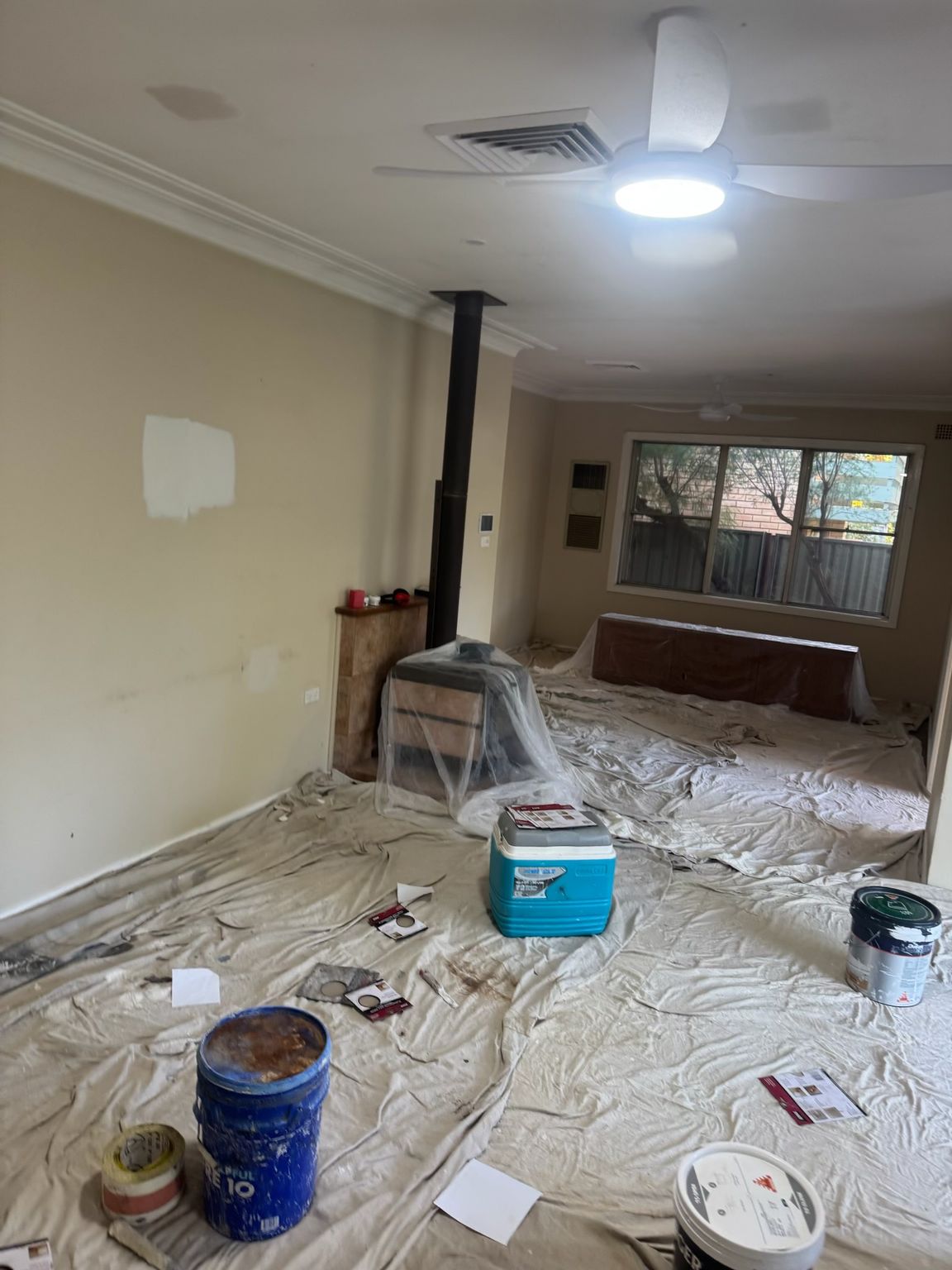 Living Room Under Renovation, Covered Floor With Drop Cloths — Robert Seeliger Painter And Decorator in Gilgandra, NSW