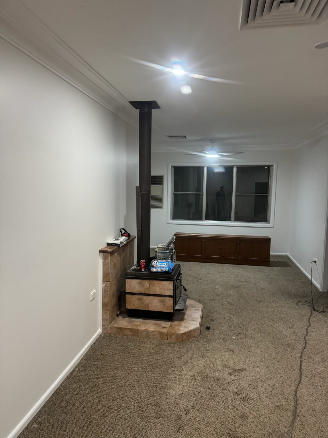 Living Room With White Walls and a Large Window at the Far End — Robert Seeliger Painter And Decorator in Wellington, NSW