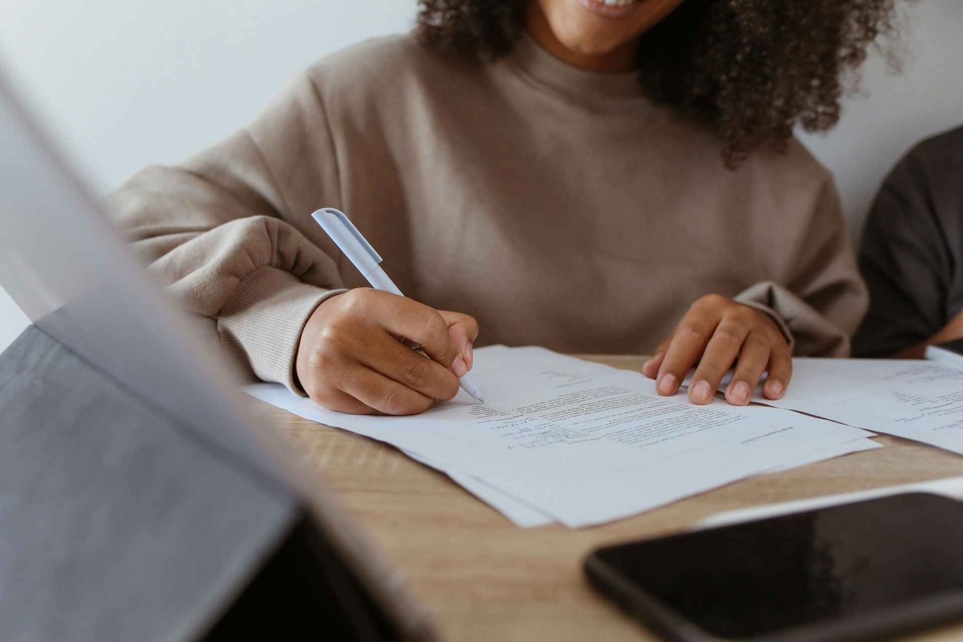 Woman writing on white paper, representing careers content writing