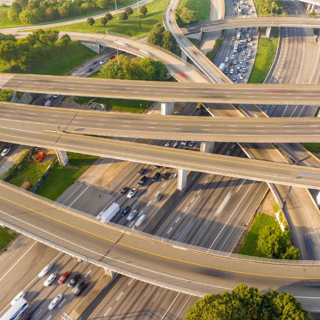 An aerial view of a highway intersection with a lot of traffic.