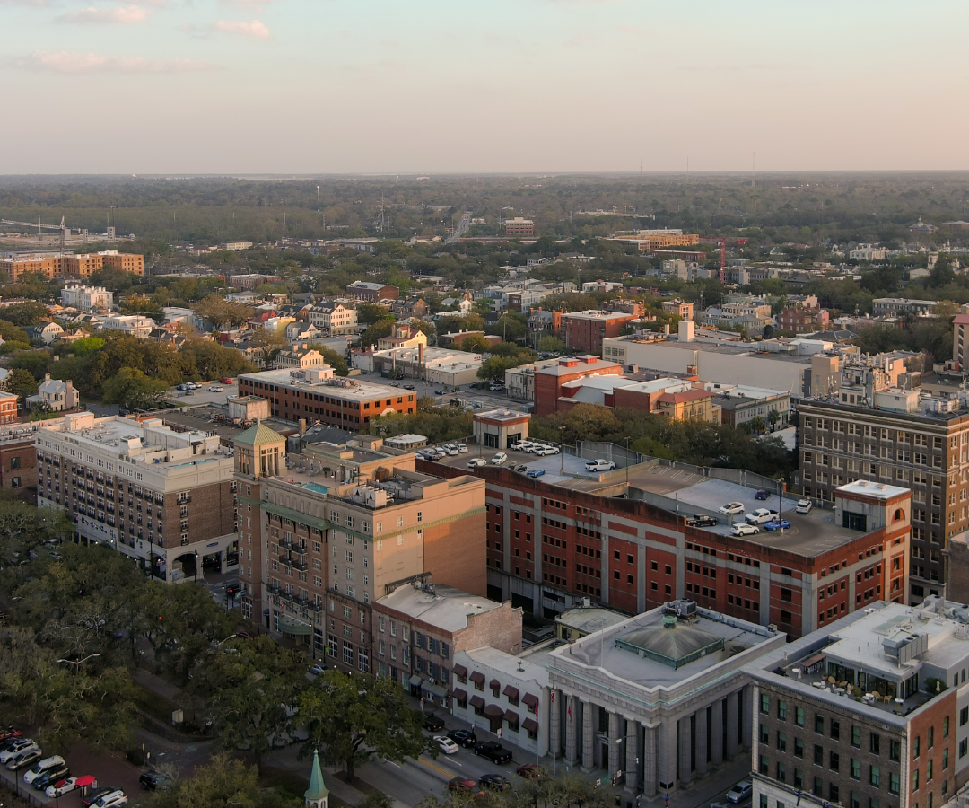 An aerial view of a city with lots of buildings and trees.