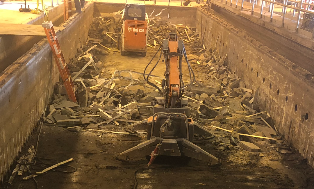 A large pile of rubble is being removed from a building.