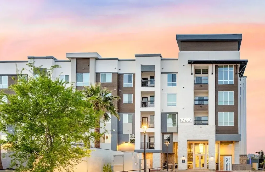 Exterior of modern apartment building with balconies and large windows at sunset at Echo Biltmore in Phoenix AZ.