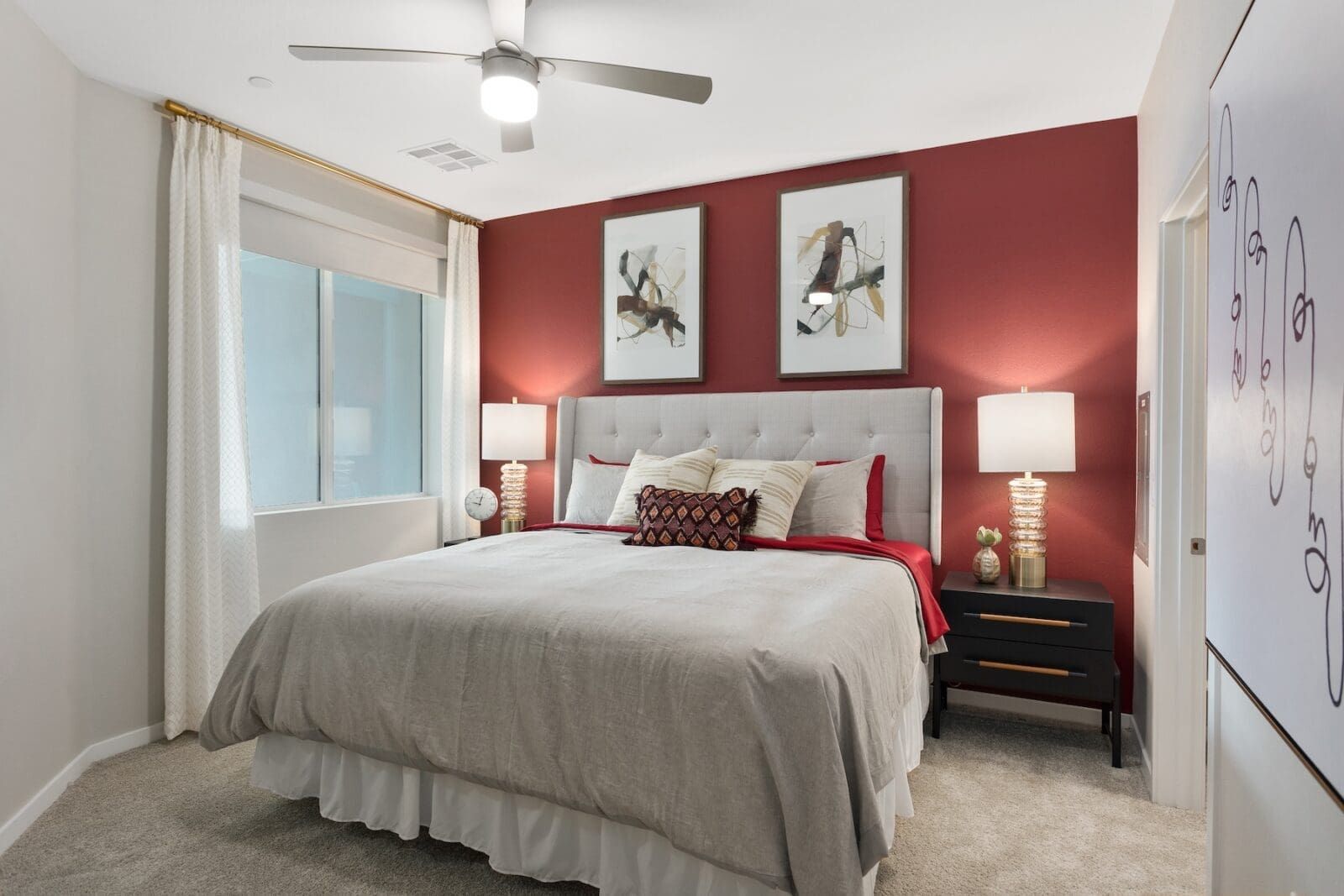 King-size bed with plush bedding in a bedroom with accent wall at Echo Biltmore in Phoenix AZ.