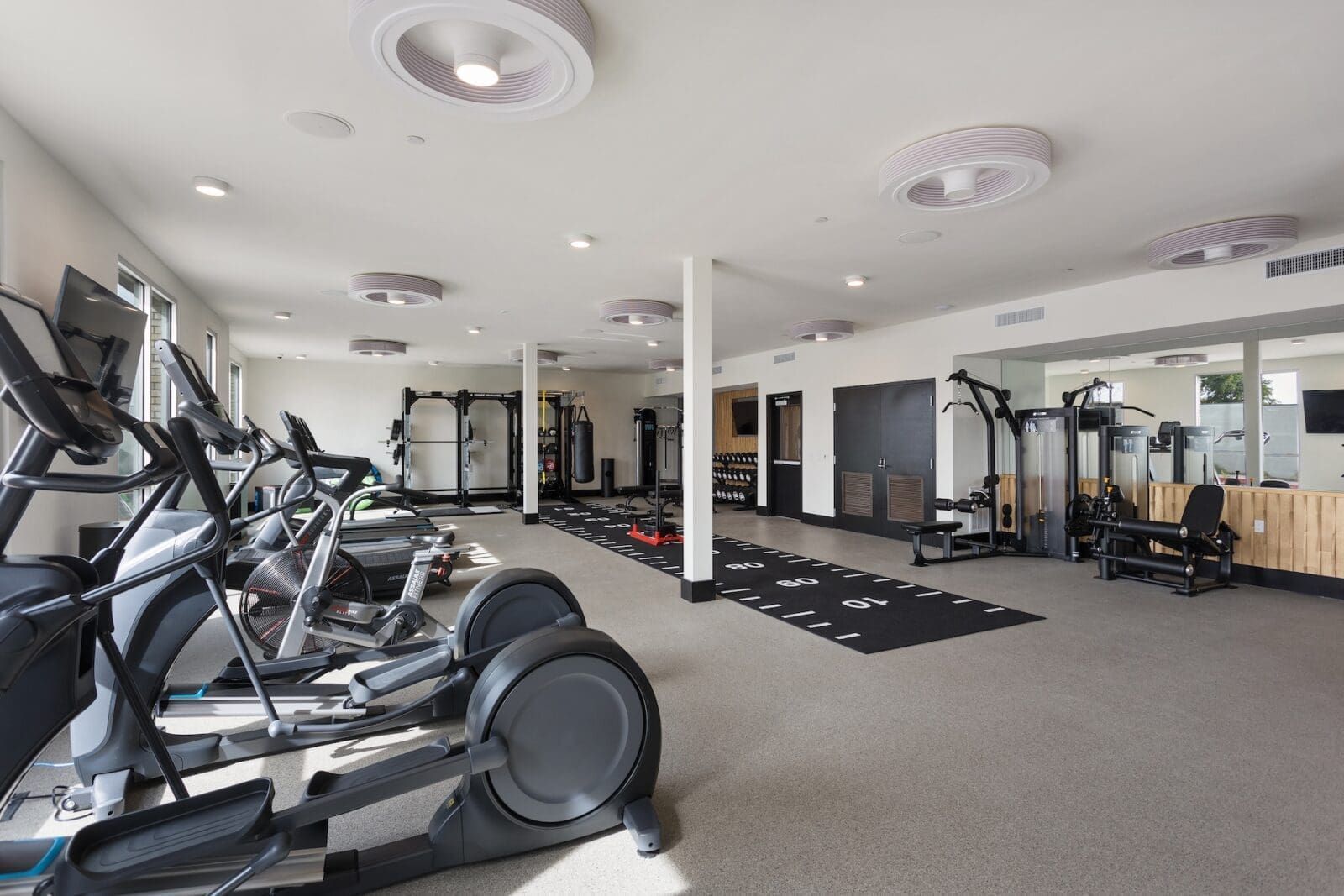 Modern fitness center with cardio machines and weight training equipment at Echo Biltmore in Phoenix AZ.