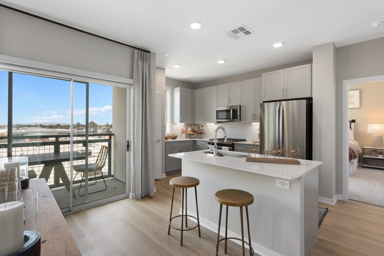 Modern kitchen with island and balcony access at Echo Biltmore in Phoenix AZ.