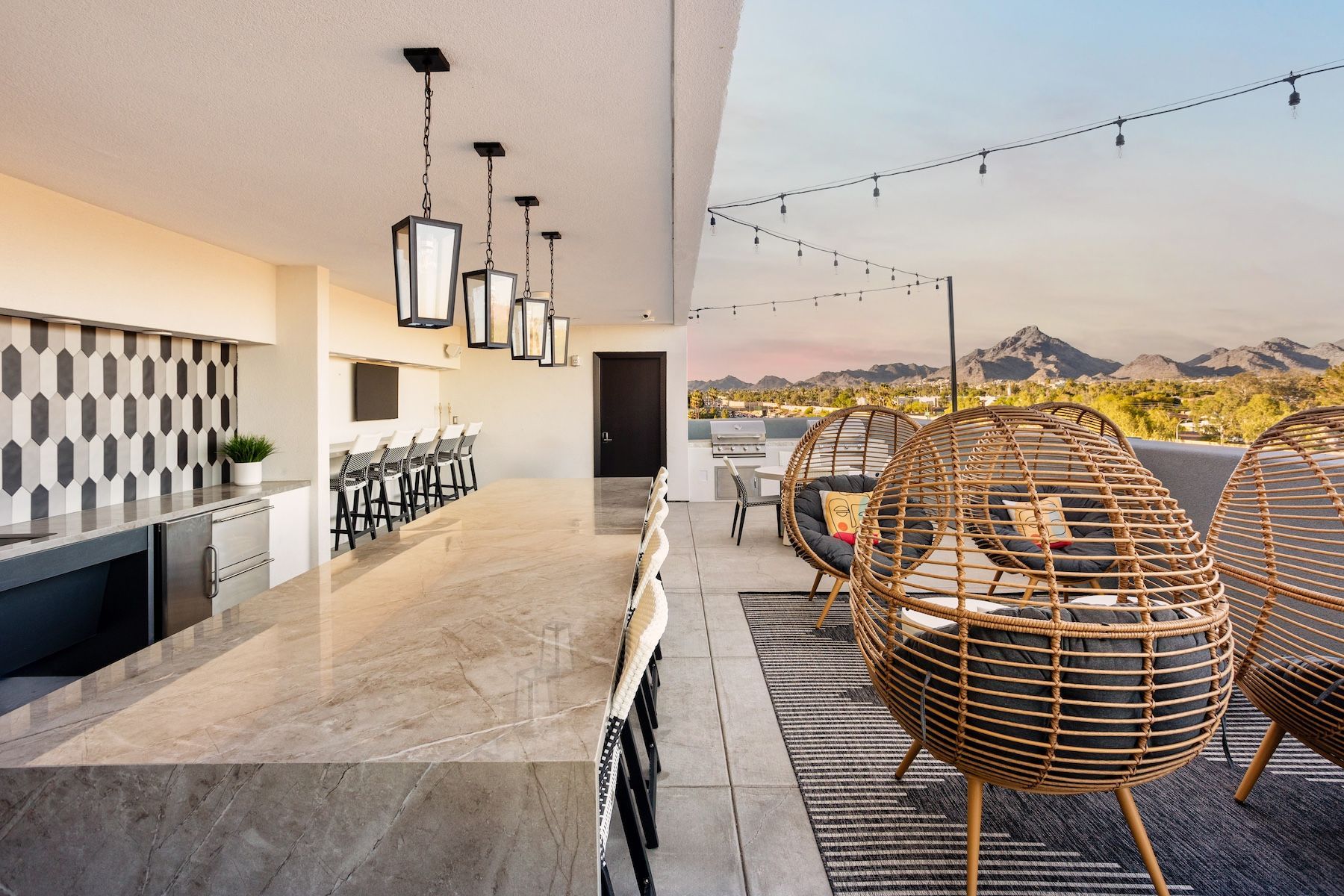 Rooftop lounge area with bar and mountain views at Echo Biltmore in Phoenix AZ.