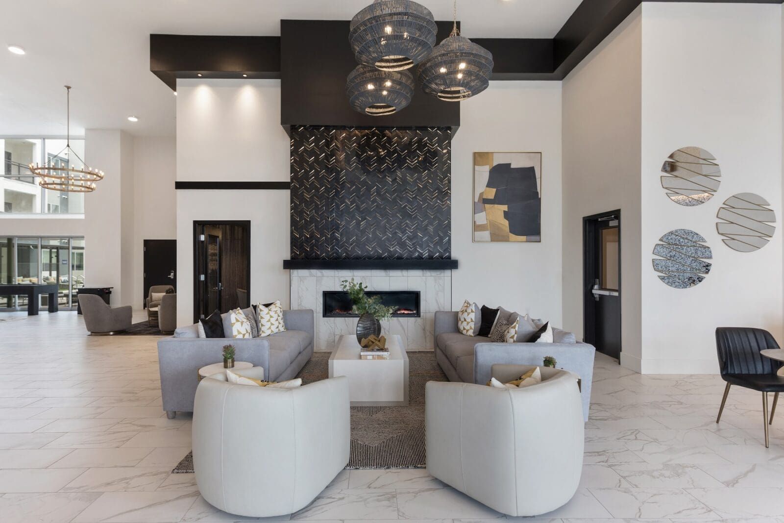 Modern lobby with seating area, fireplace, and abstract art at Echo Biltmore in Phoenix AZ.